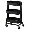Black RÅSKOG trolley with three shelves and wheels. Modern storage design for small spaces.