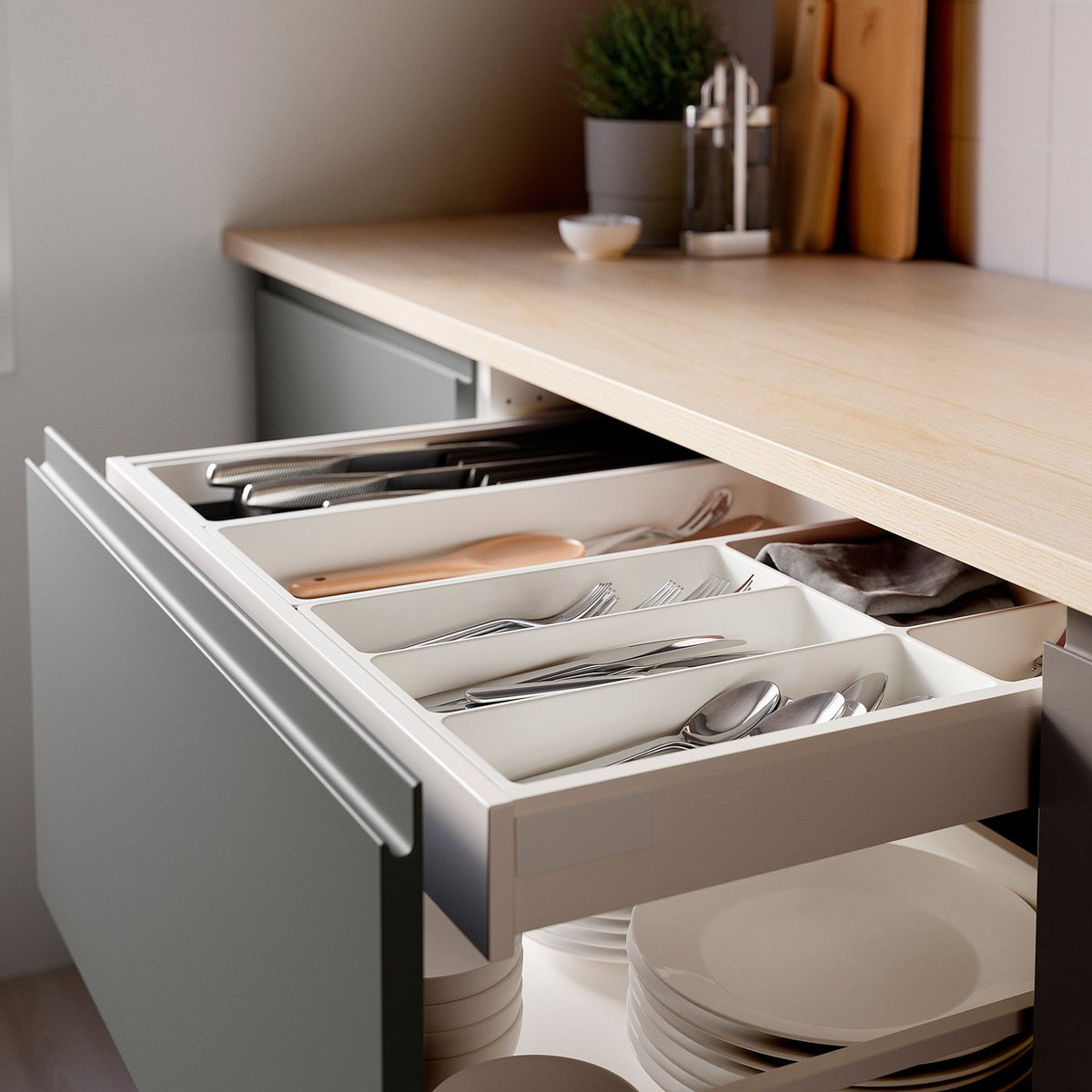 Open kitchen drawer with white UPPDATERA cutlery tray. Trays store and organise utensils neatly.