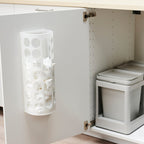 White VARIERA bag dispenser on cabinet door for organising plastic bags.